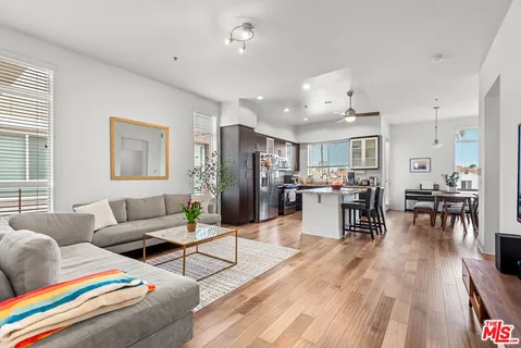 a living room with furniture and kitchen view