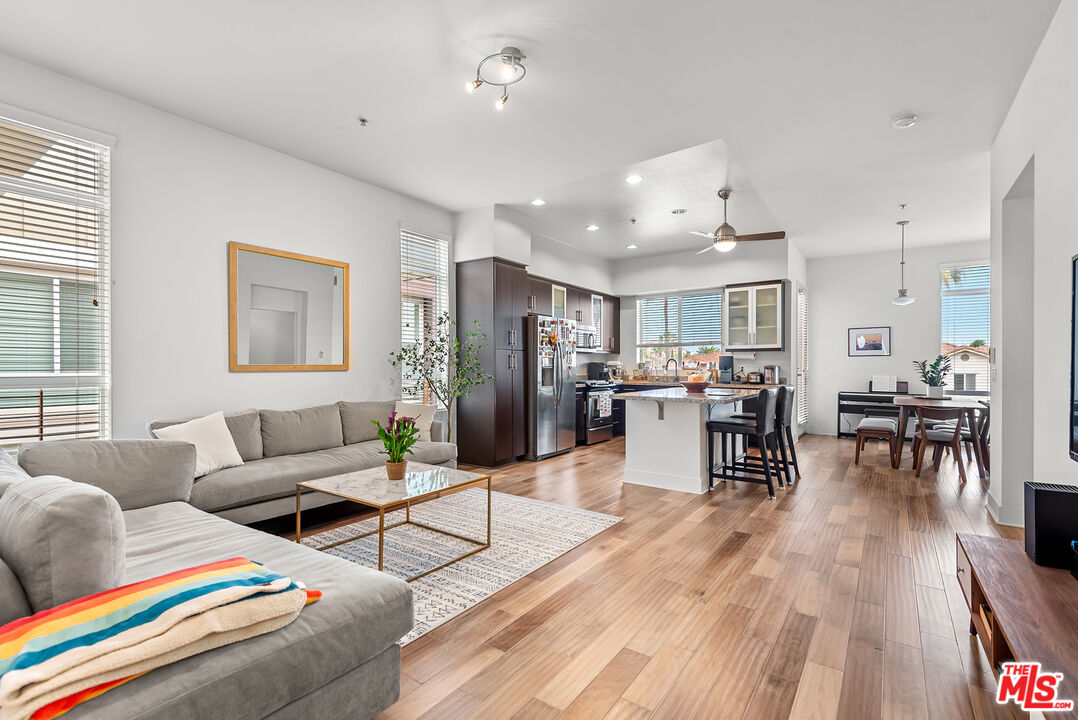 a living room with furniture and kitchen view