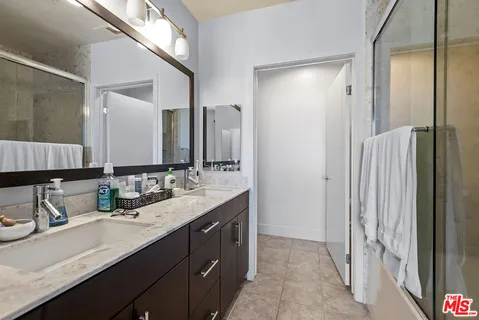 a view of walk in closet with clothes