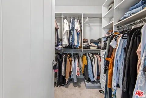 a bedroom with a bed and a chair