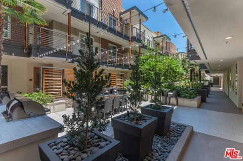 a outdoor space with lots of tables a garden view and chairs