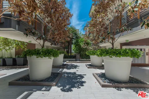 a view of a patio with couches and potted plants