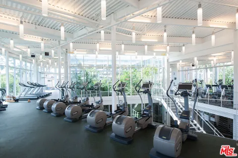 a view of swimming pool with lawn chairs and potted plants
