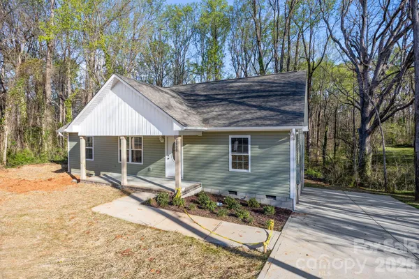 a front view of house with yard outdoor seating and barbeque oven
