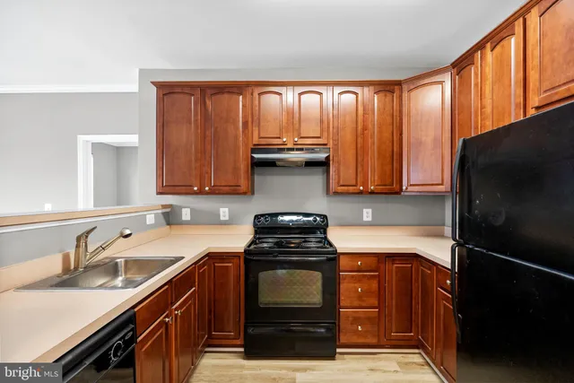 a kitchen with stainless steel appliances sinks and a large window
