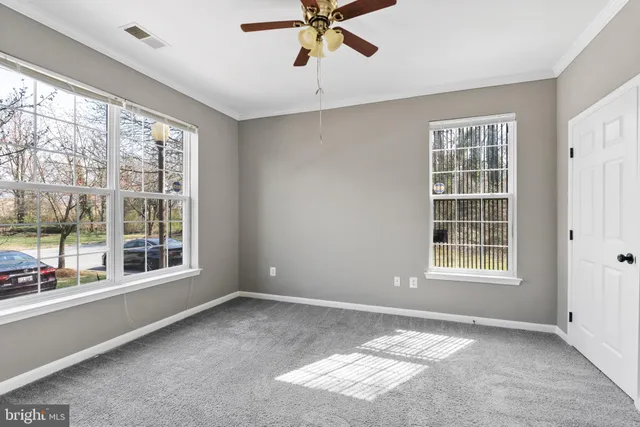 a view of room with window and ceiling fan
