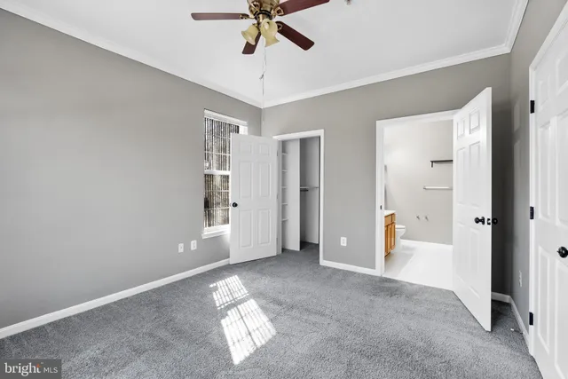 a view of walk in closet with empty racks