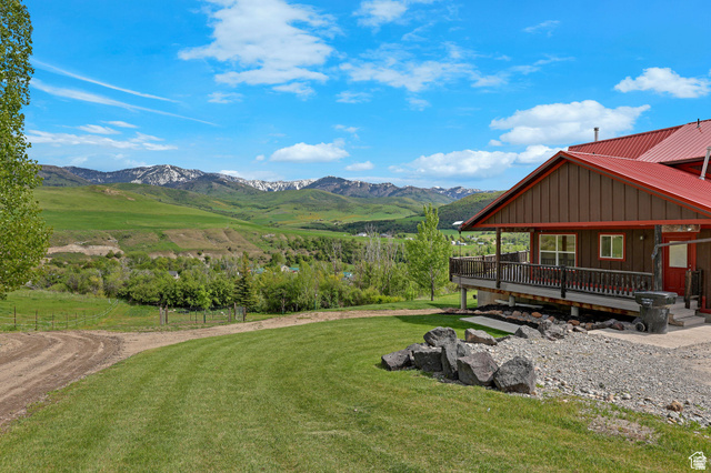 306 Spring Road Preston, ID 83263 - Photo 46 of 55 Expansive green landscape with distant snow-capped mountains