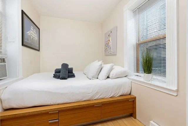 a bedroom with a bed and a window