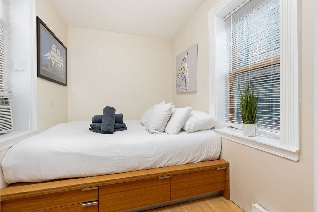 0 Hull Street, Unit F Boston, MA 02113 - Photo 12 of 14 a bedroom with a bed and a window