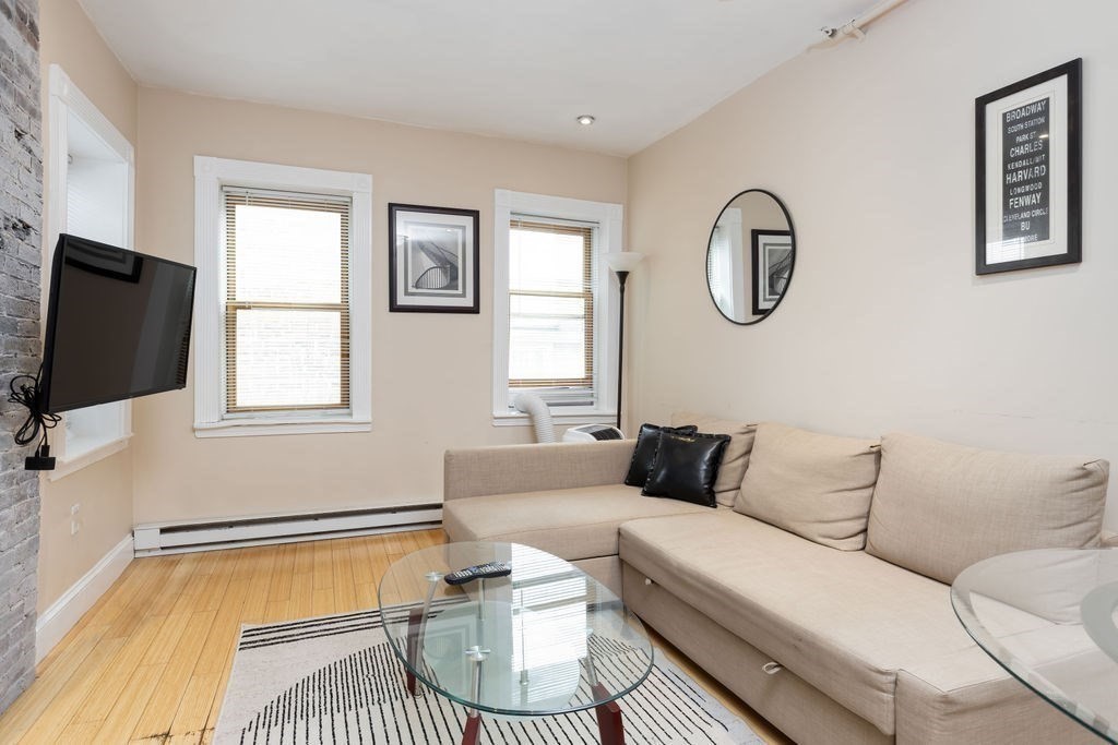 0 Hull Street, Unit F Boston, MA 02113 - Photo 3 of 14 a living room with furniture and a flat screen tv