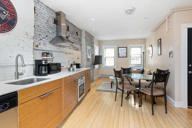 a large kitchen with a table and chairs