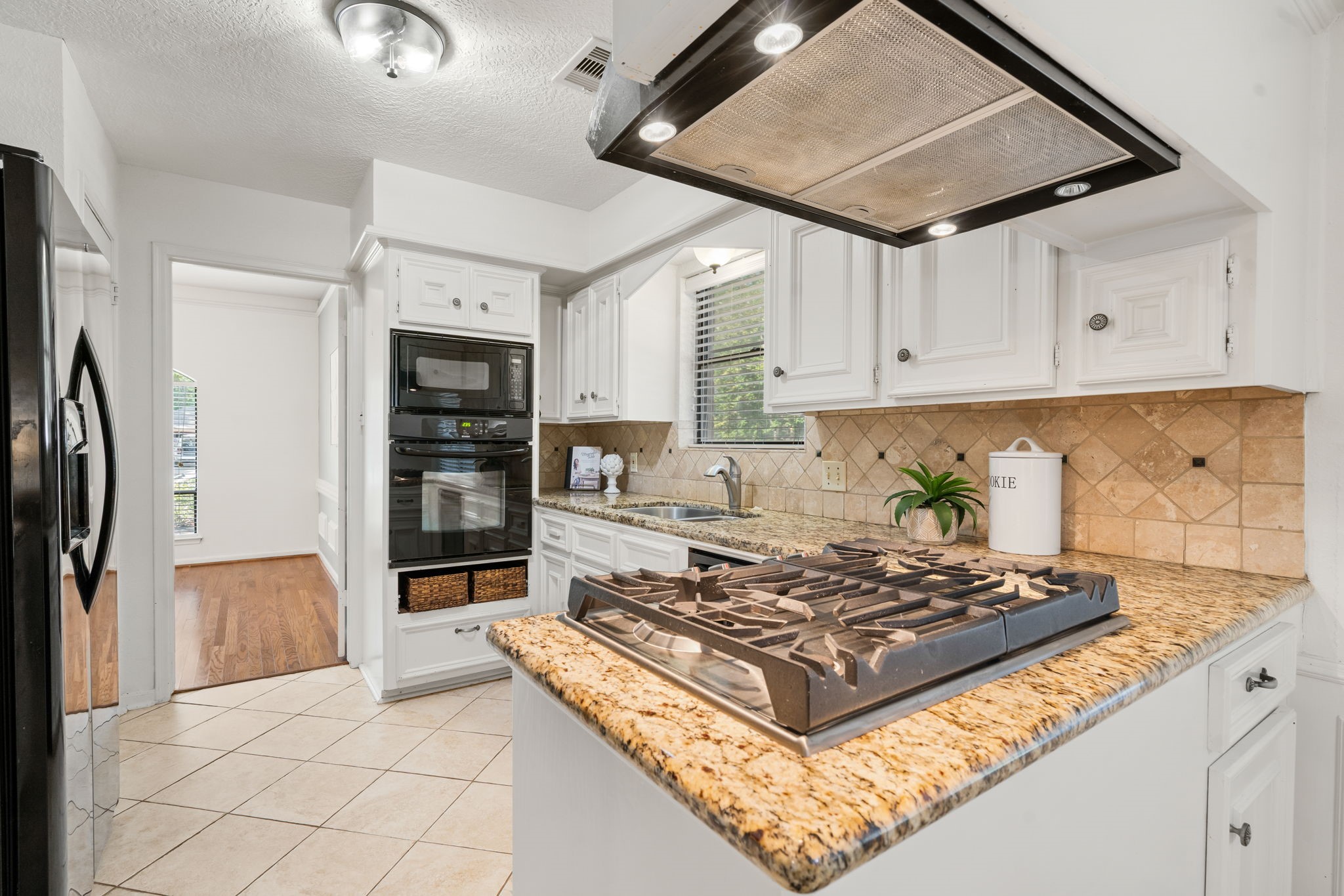 6403 Willow Pine Drive Spring, TX 77379 - Photo 14 of 40 This kitchen boasts a gas range, ample prep space on the granite countertops, and a crisp look with sleek black appliances.