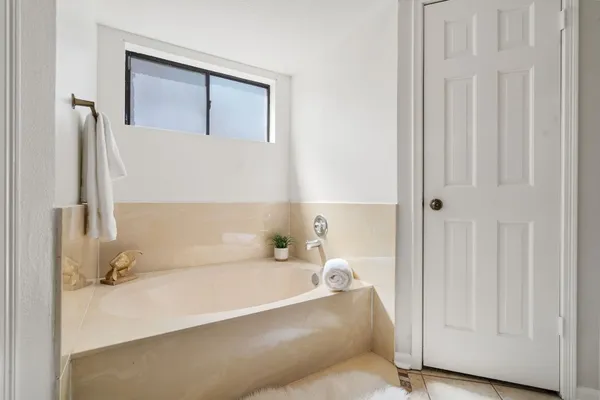 a bathroom with a bathtub and shower