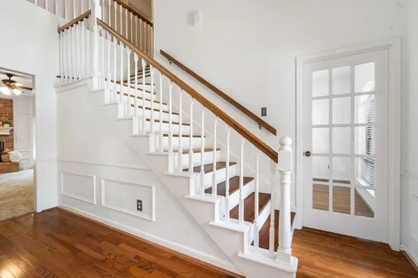 a view of entryway and hall with wooden floor
