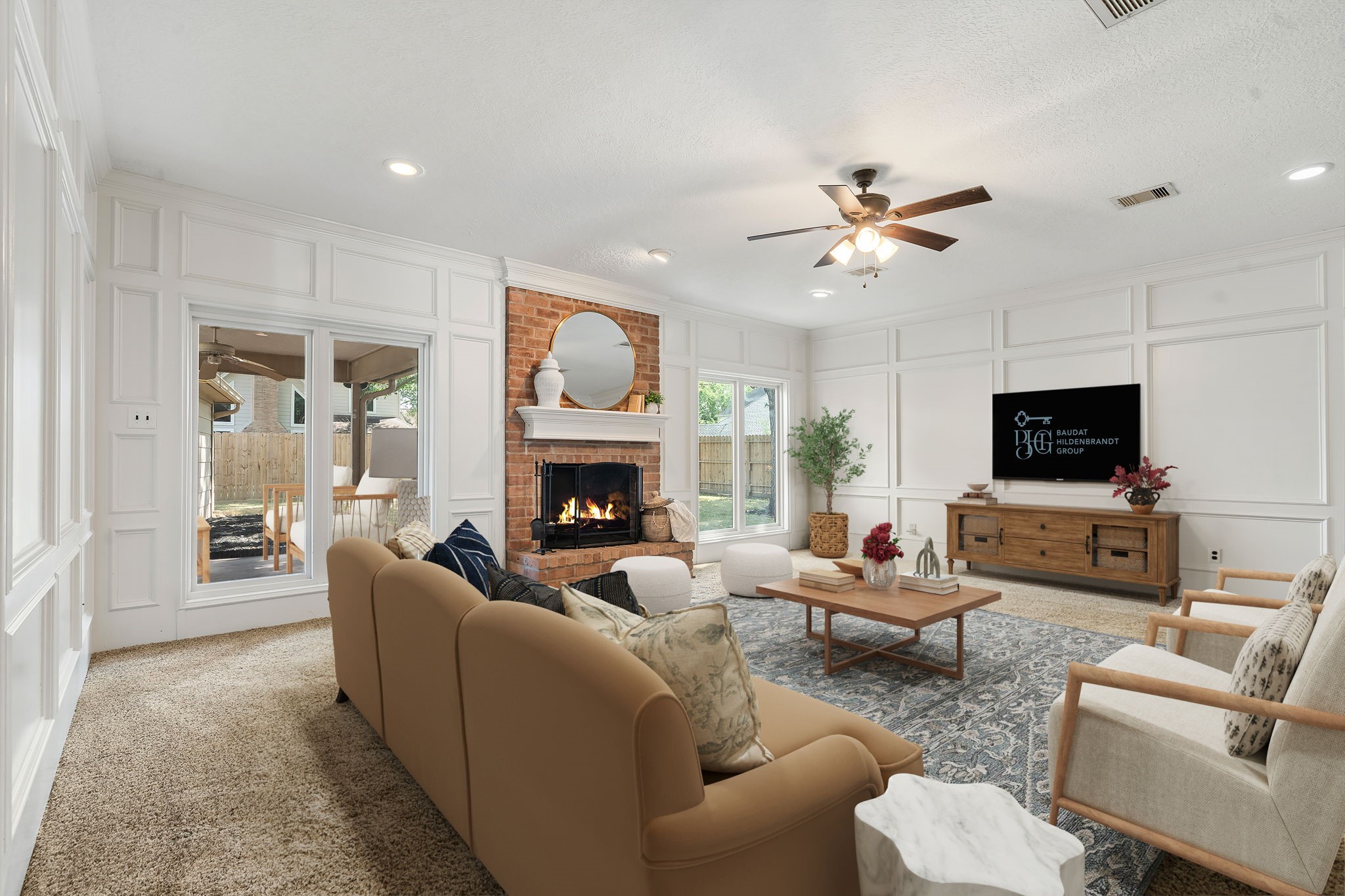 6403 Willow Pine Drive Spring, TX 77379 - Photo 5 of 40 This spacious virtually staged living room is anchored by a cozy brick gaslog fireplace and features elegant custom wainscot paneling. Large windows and recessed lighting create a bright, inviting atmosphere.