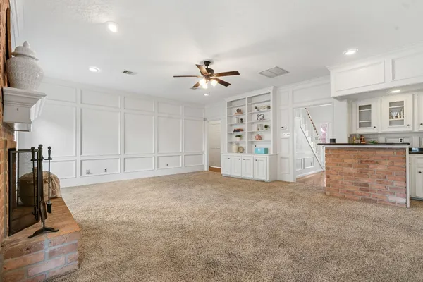 a view of a livingroom with furniture a ceiling fan and window