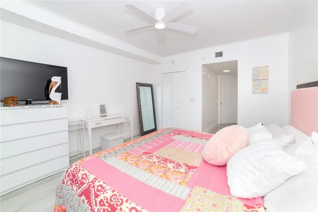 a bedroom with a bed and a desk