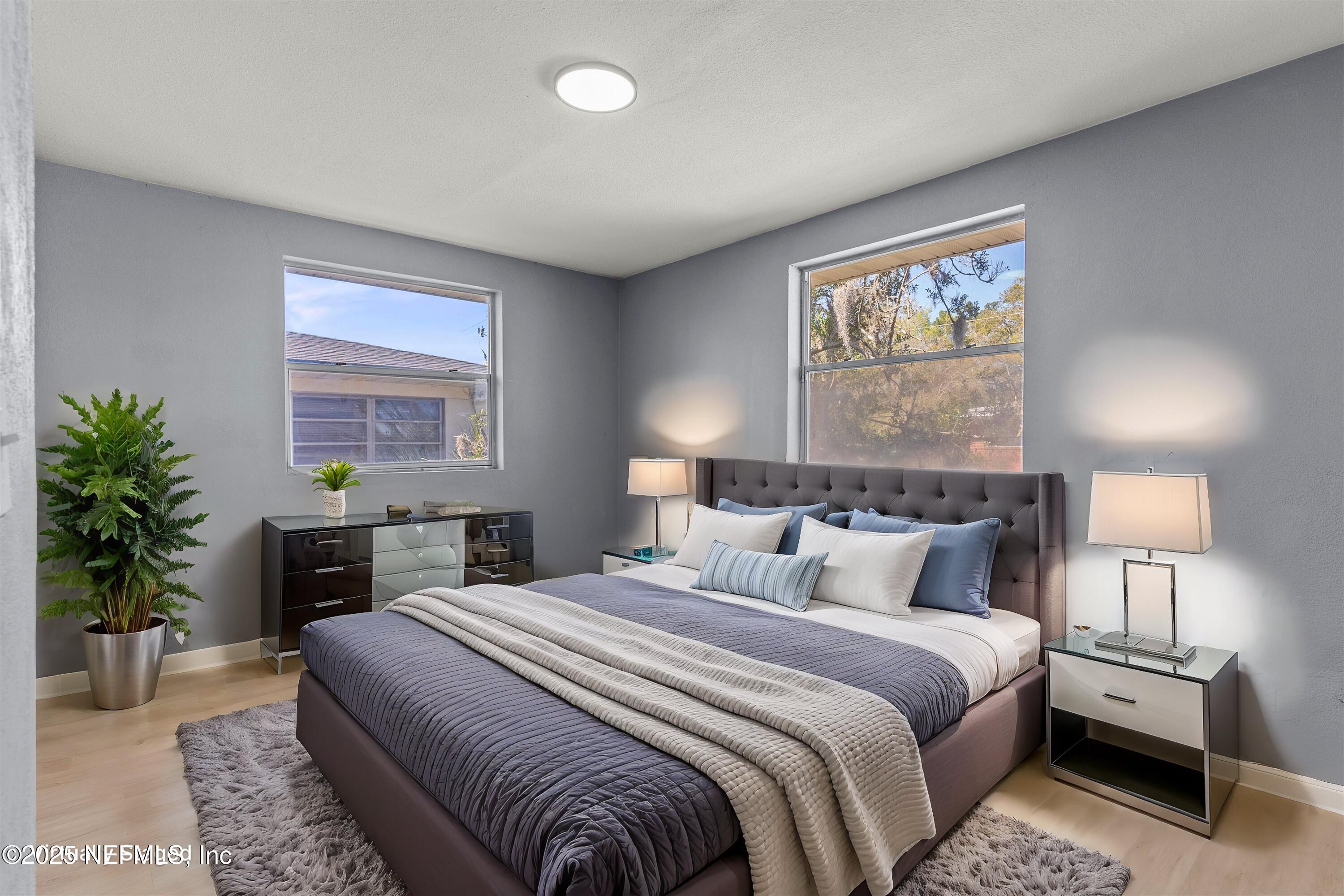 3150 Belden Circle Jacksonville, FL 32207 - Photo 27 of 69 a bedroom with a bed and a lamp on dresser