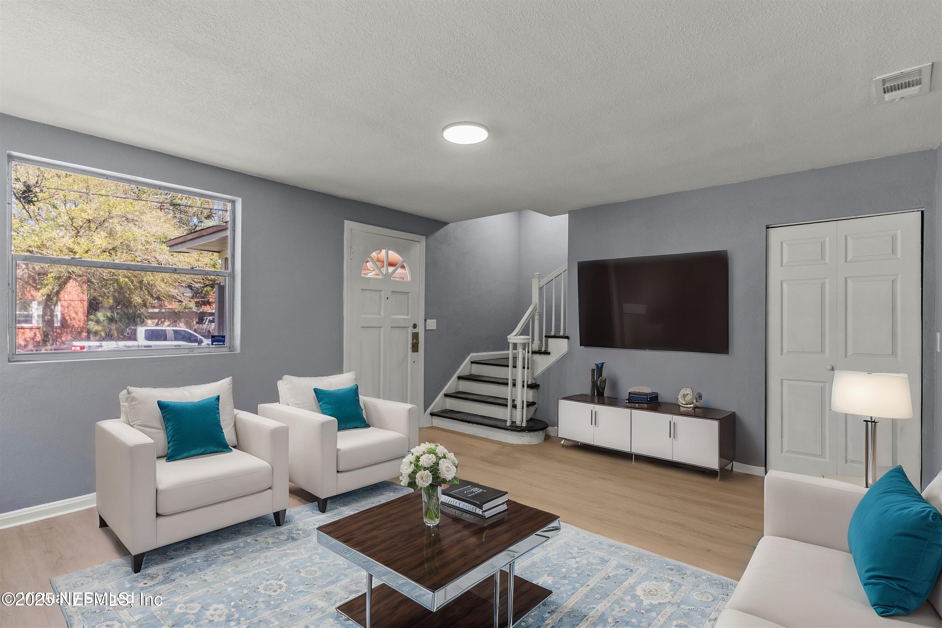 3150 Belden Circle Jacksonville, FL 32207 - Photo 41 of 69 a living room with furniture and a flat screen tv