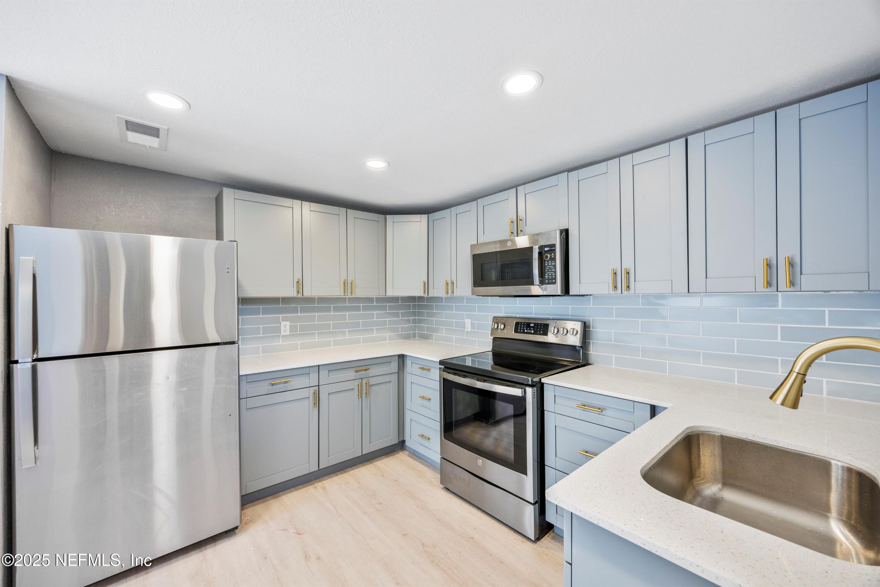 3150 Belden Circle Jacksonville, FL 32207 - Photo 47 of 69 a kitchen with stainless steel appliances granite countertop a refrigerator sink and stove
