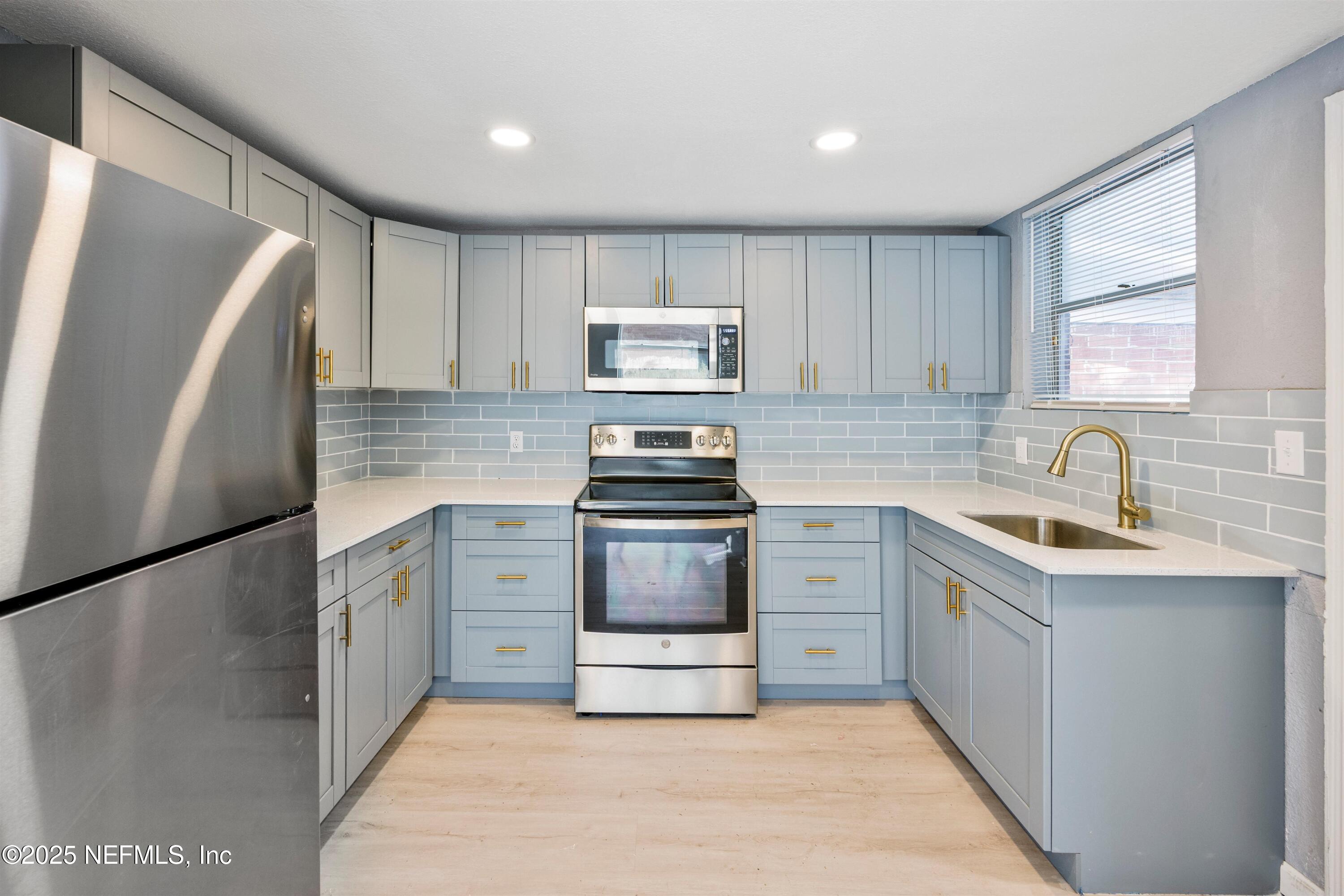 3150 Belden Circle Jacksonville, FL 32207 - Photo 48 of 69 a kitchen with a refrigerator stove and sink