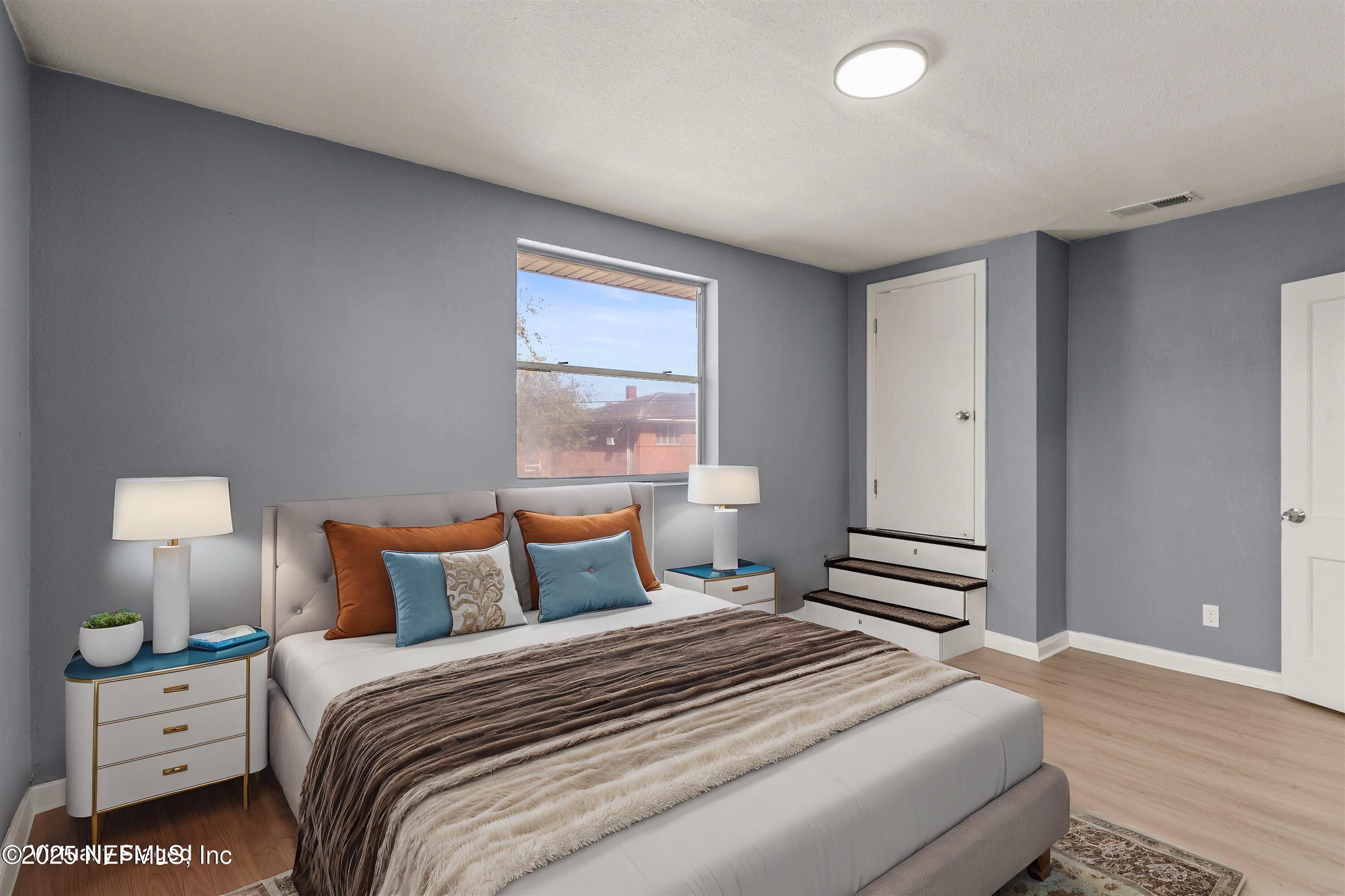 3150 Belden Circle Jacksonville, FL 32207 - Photo 53 of 69 a bedroom with a bed and a night stand