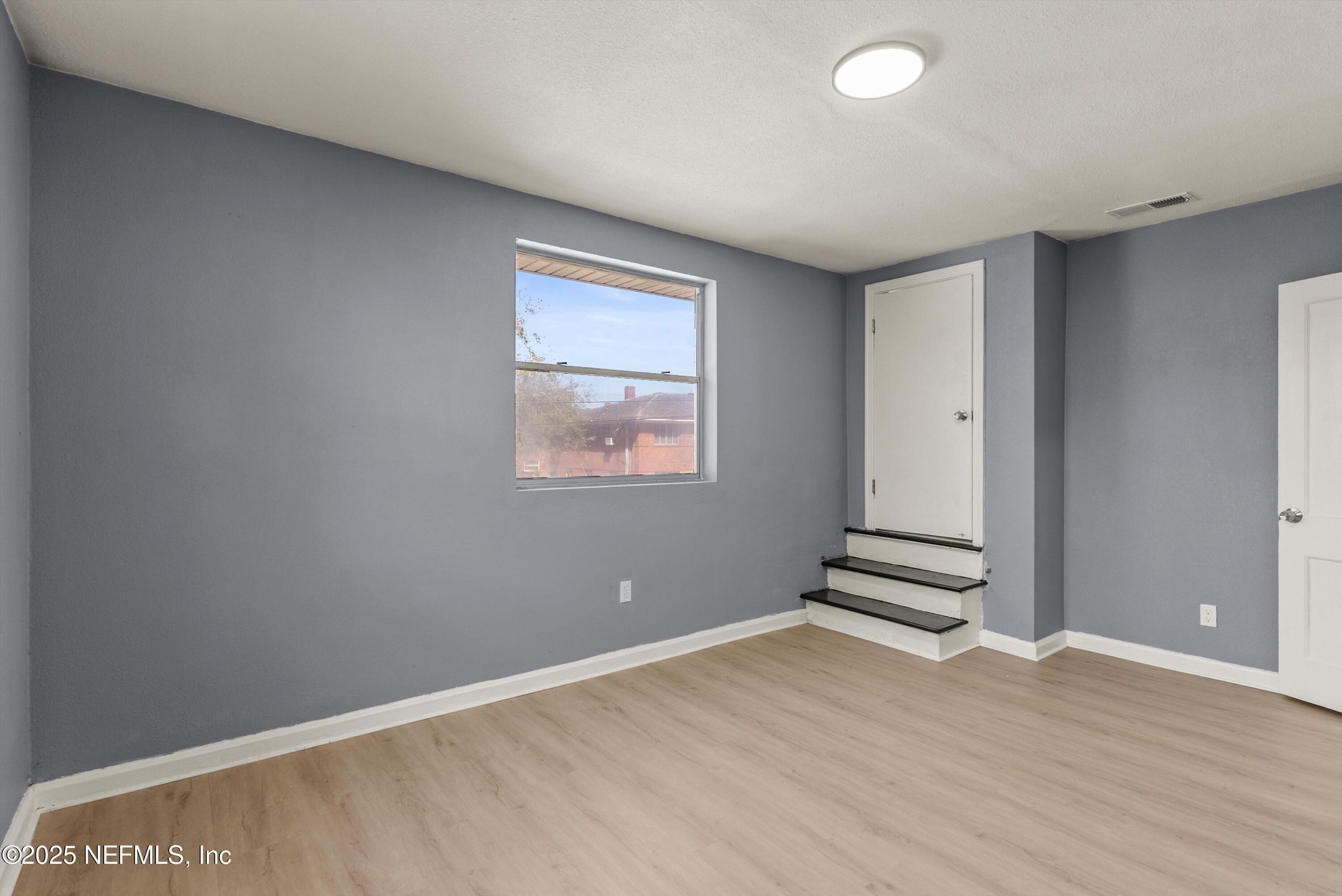 3150 Belden Circle Jacksonville, FL 32207 - Photo 54 of 69 an empty room with wooden floor and windows