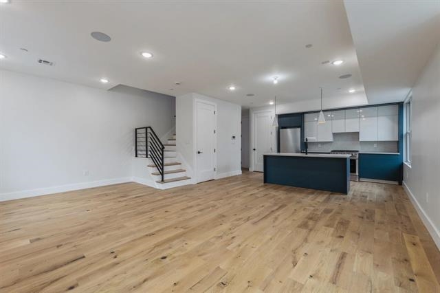 a view of kitchen and refrigerator
