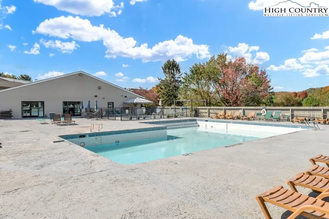 a view of swimming pool with outdoor seating
