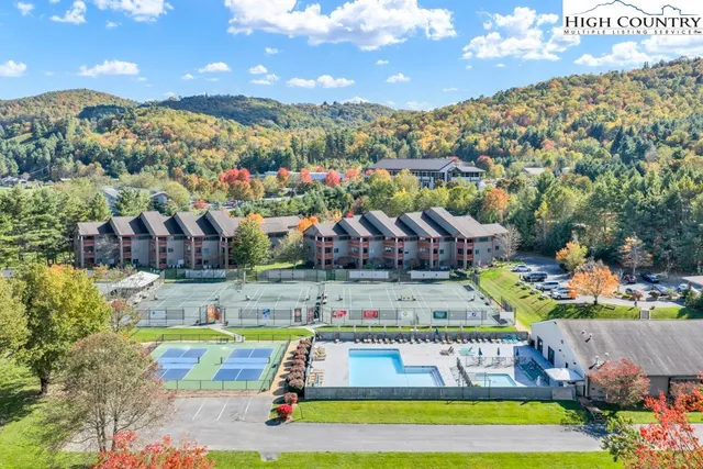 a view of swimming pool with outdoor seating and a garden