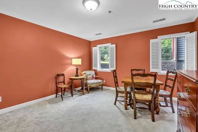 a dining room with furniture and windows