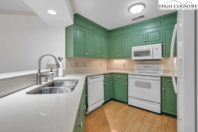 a kitchen with a sink cabinets and stainless steel appliances