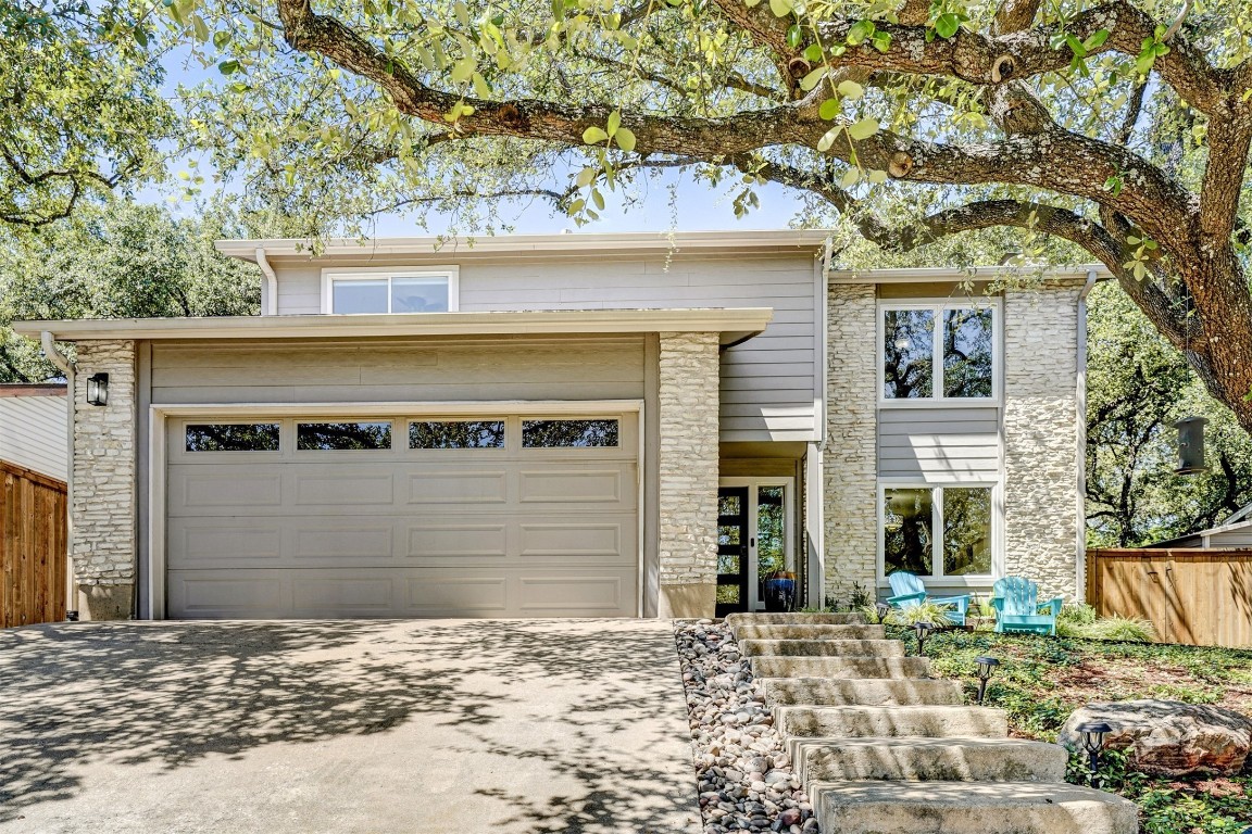 a front view of a house with a yard and garage