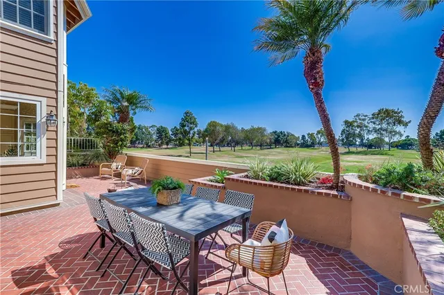 a living room with a flat screen tv and a ceiling fan