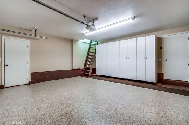 a view of wooden floor and a chandelier in a room