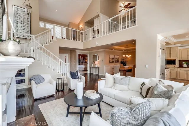 a living room with furniture a fireplace and a large window