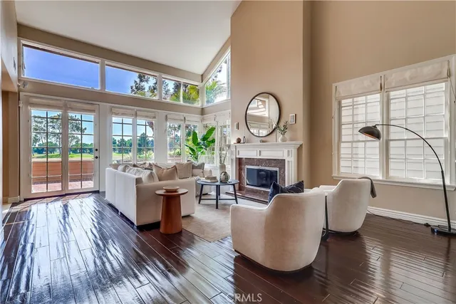 a living room with furniture a fireplace and a large window