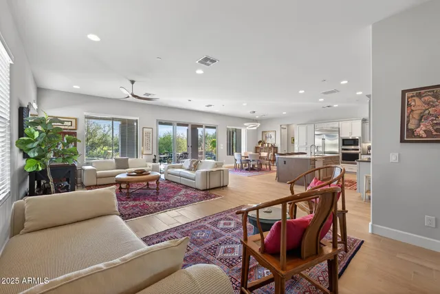 a spacious bedroom with a bed a couch and a large window