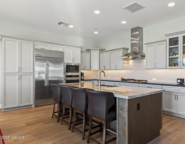 a spacious bathroom with a granite countertop double vanity and a large mirror