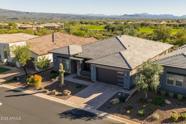 an aerial view of a house with a ocean view