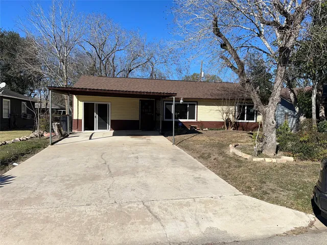 a view of a backyard with a large tree