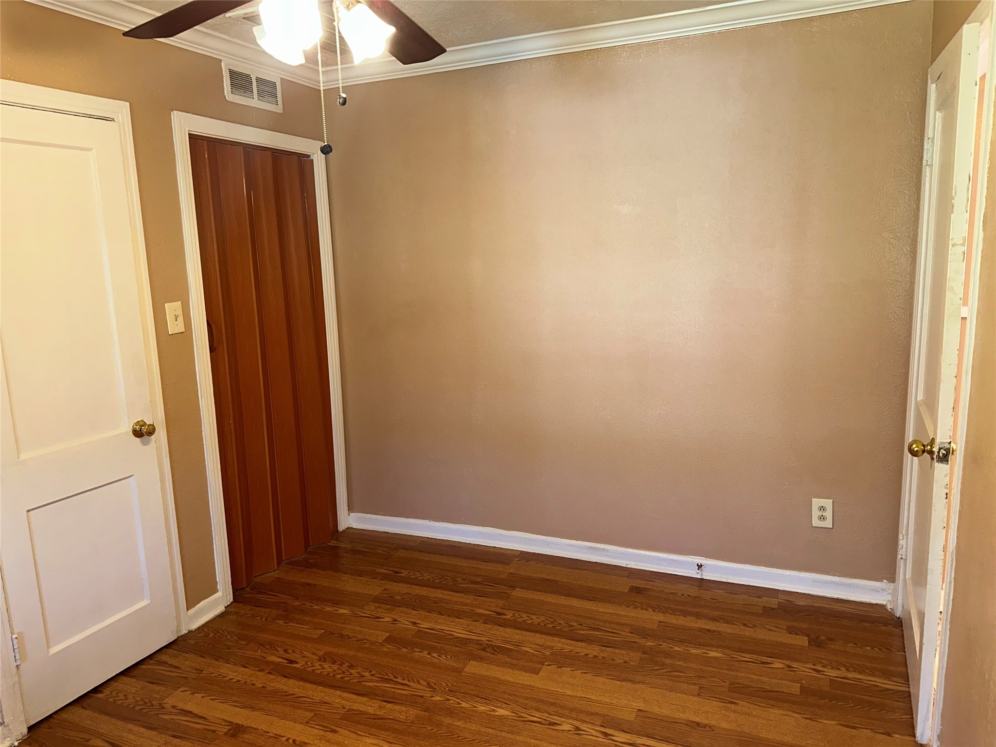 5715 Beldart Street Houston, TX 77033 - Photo 11 of 12 a view of an empty room with wooden floor