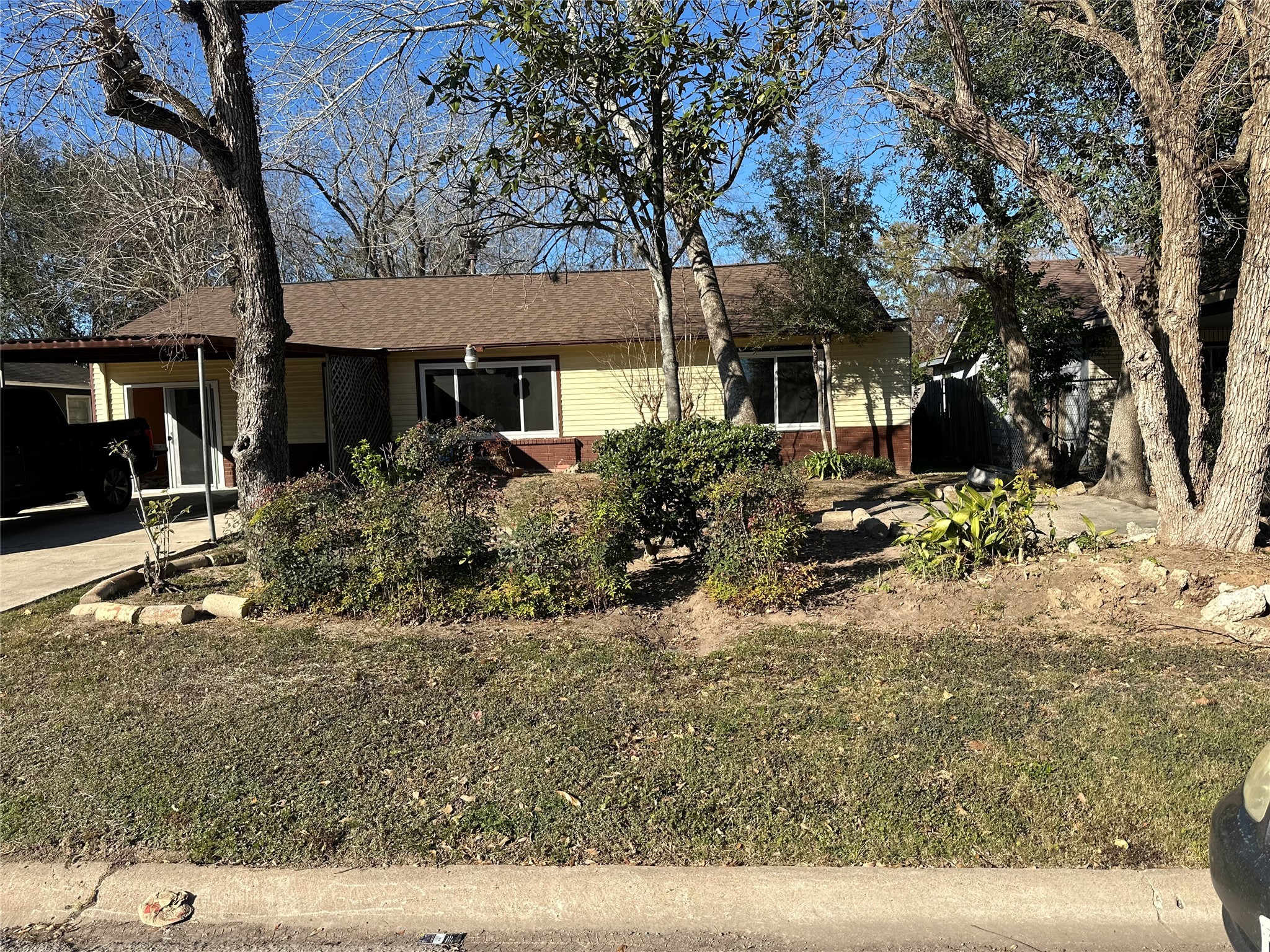 5715 Beldart Street Houston, TX 77033 - Photo 2 of 12 a view of a house with a yard covered in snow