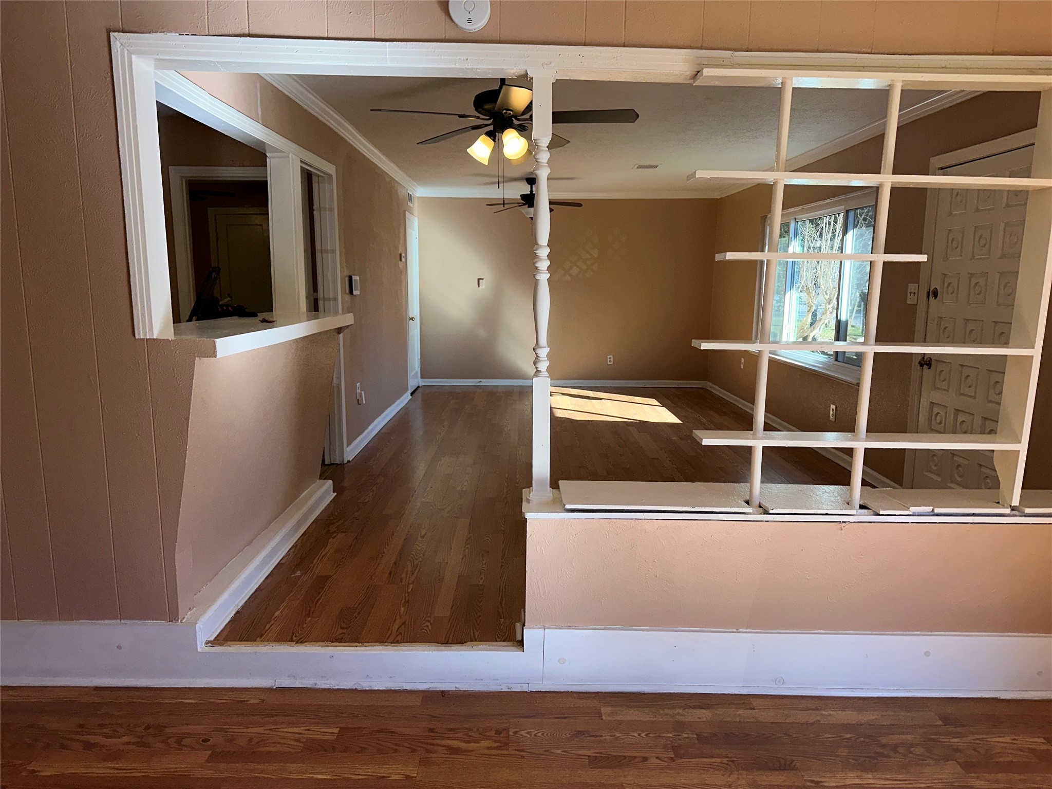 5715 Beldart Street Houston, TX 77033 - Photo 4 of 12 a view of an empty room with wooden floor and chandelier