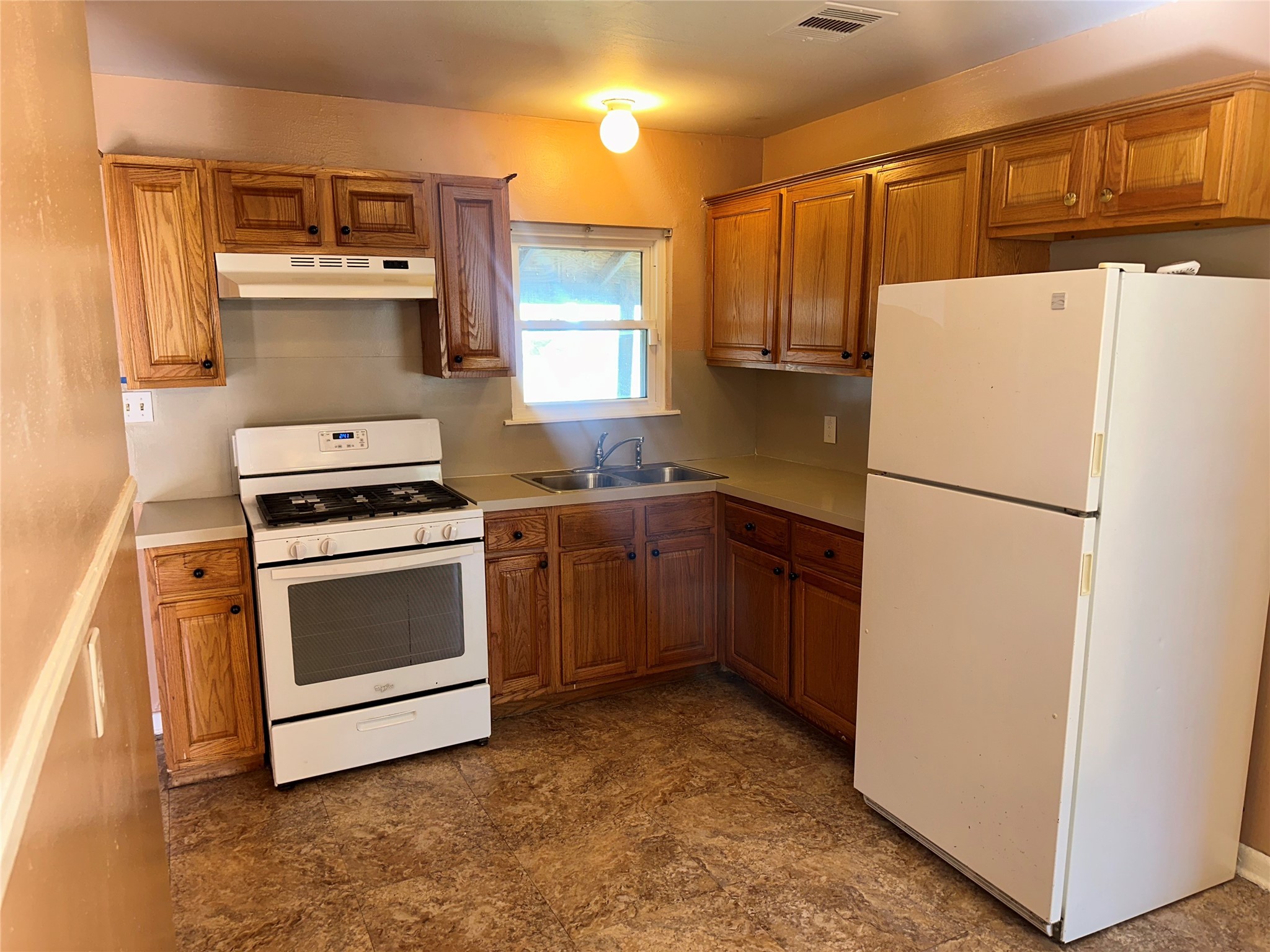 5715 Beldart Street Houston, TX 77033 - Photo 7 of 12 a kitchen with a refrigerator stove and microwave