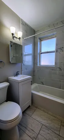 a bathroom with a sink a toilet and bathtub
