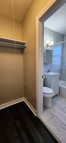 a bathroom with a toilet a sink and mirror