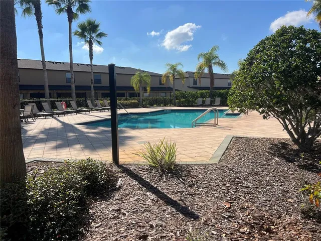 a view of a swimming pool with a lounge chairs