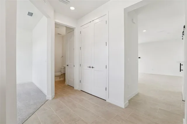 an empty room with windows and closet